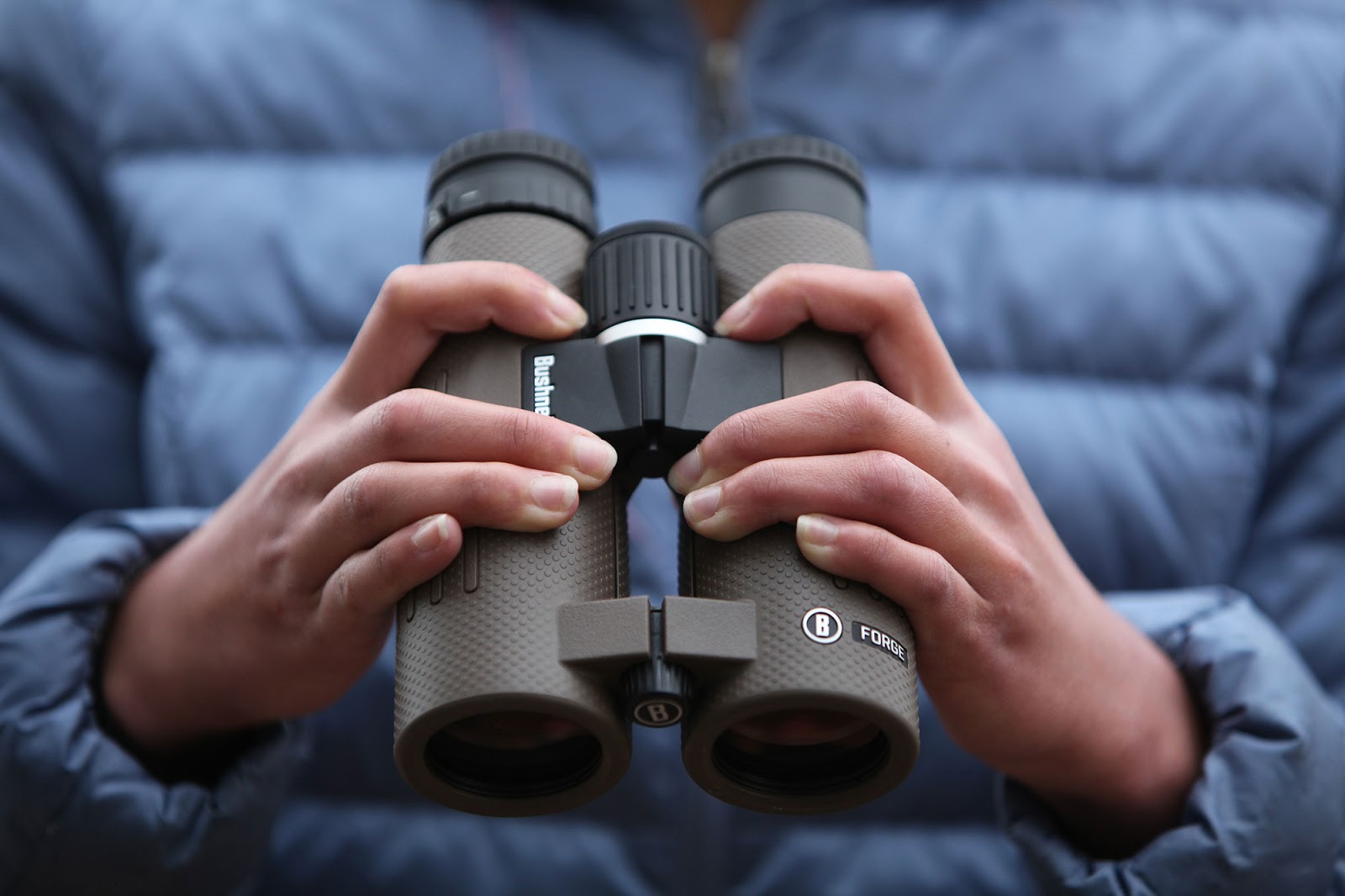 Person holding Bushnell Forge Binoculars