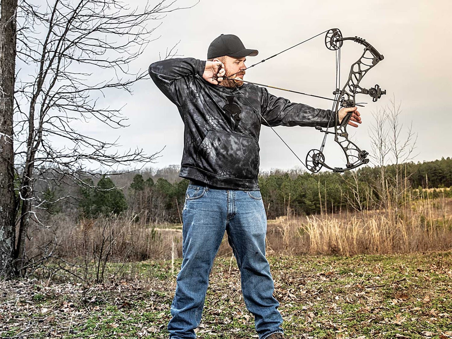 Guy at full draw with a compound bow