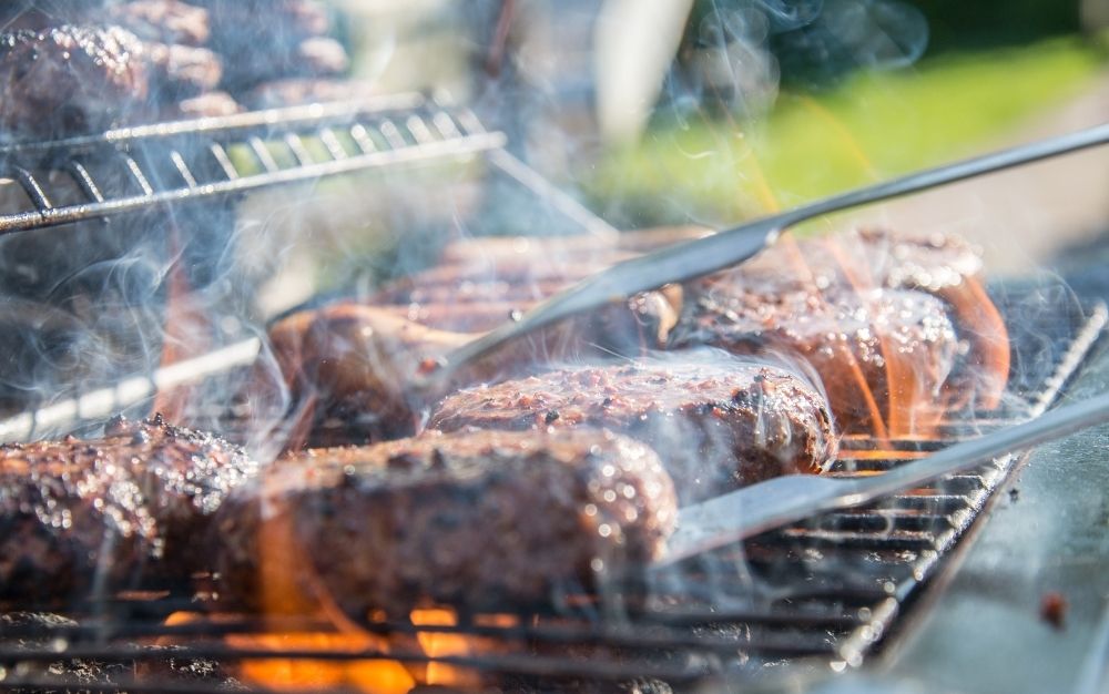 Burgers cooking on a grill for the best prime day deals