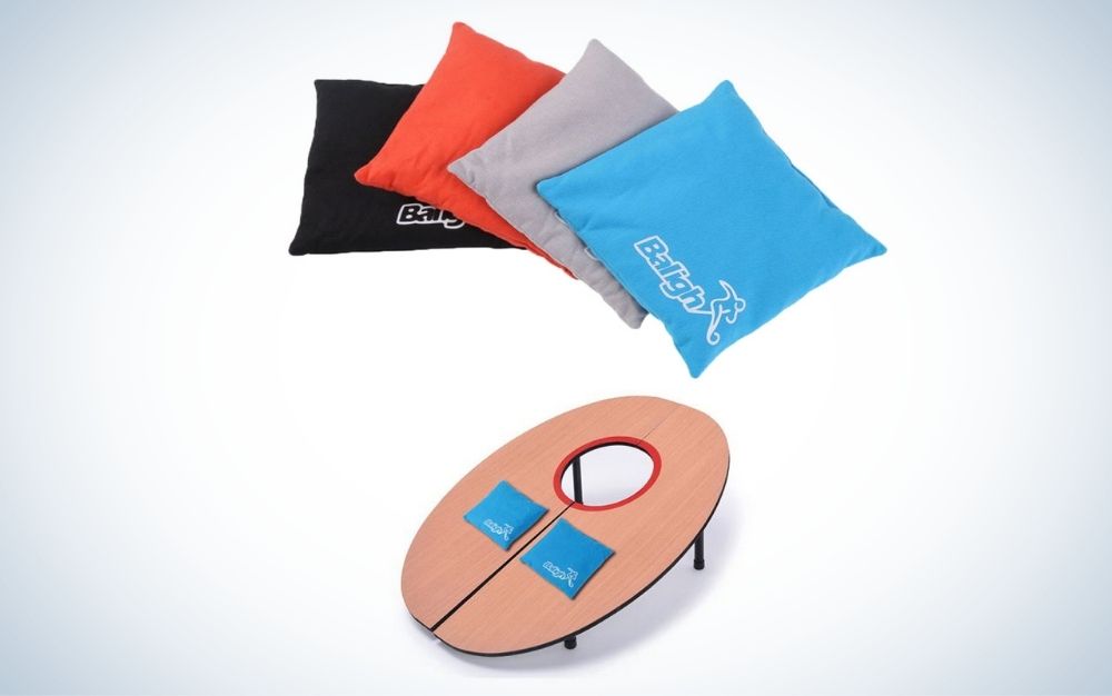 Four pillows in four different colors and a wooden board with a hole in the top, as well as two small pillows in different colors.