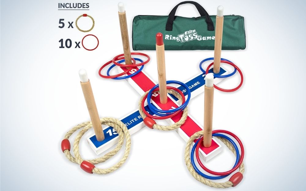 Five wooden sticks and some different colored circles placed inside them, as well as a large green bag next to them.