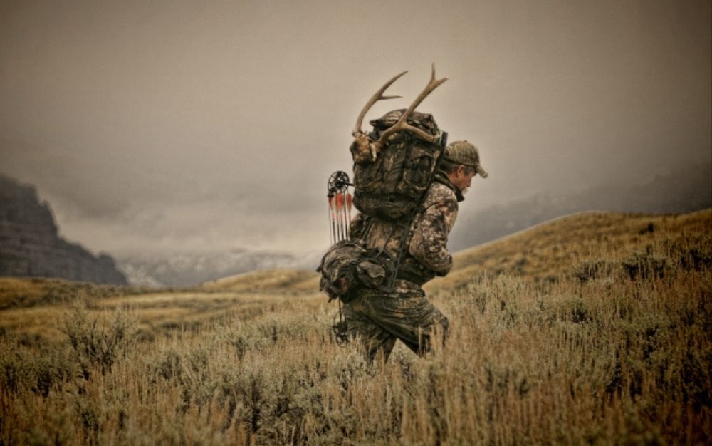 Person walking and carrying a hunting backpack