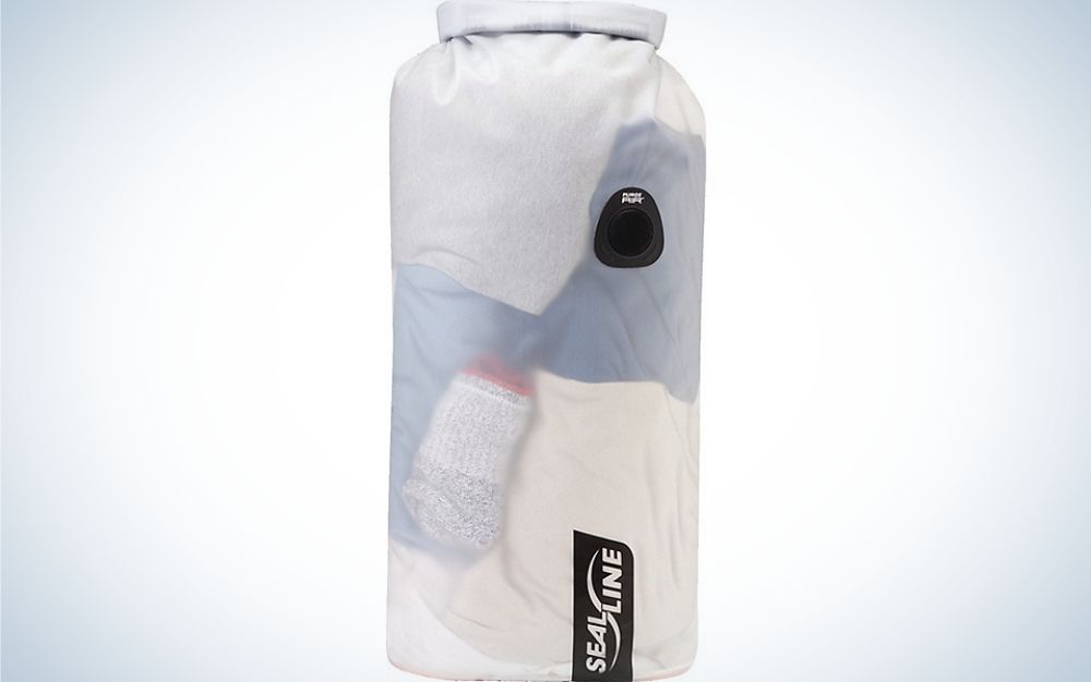 A large bag similar to a boxing bag which is white with water shades as well as with two black stripes and in the shape of a cylinder.