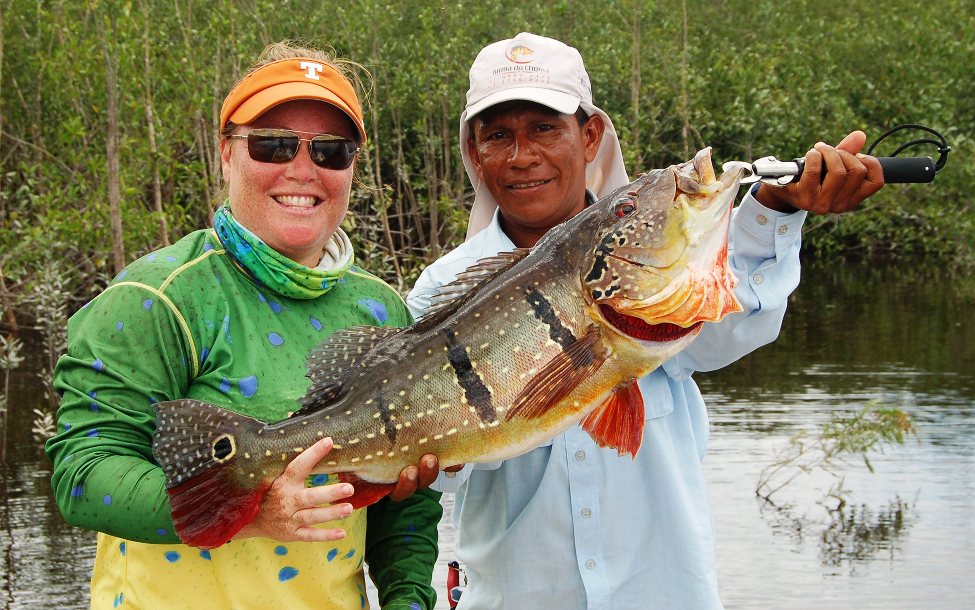 Two anglers weigh giant fish with boga grip.