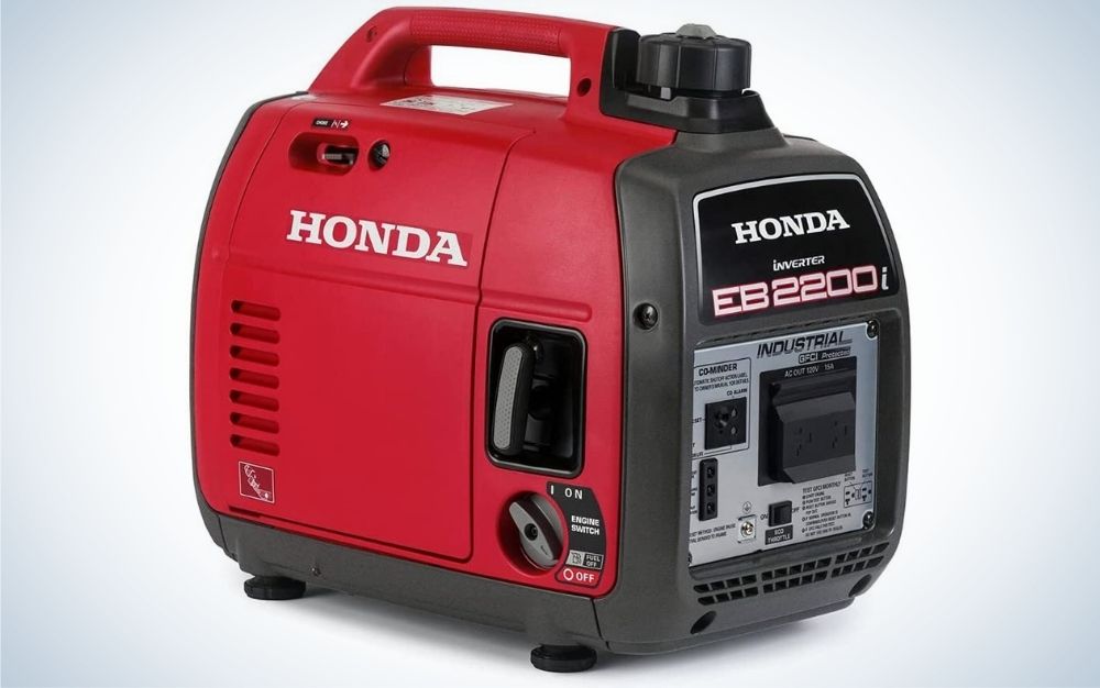 A Honda generator in the form of a large suitcase which is red in color and with a black holder.