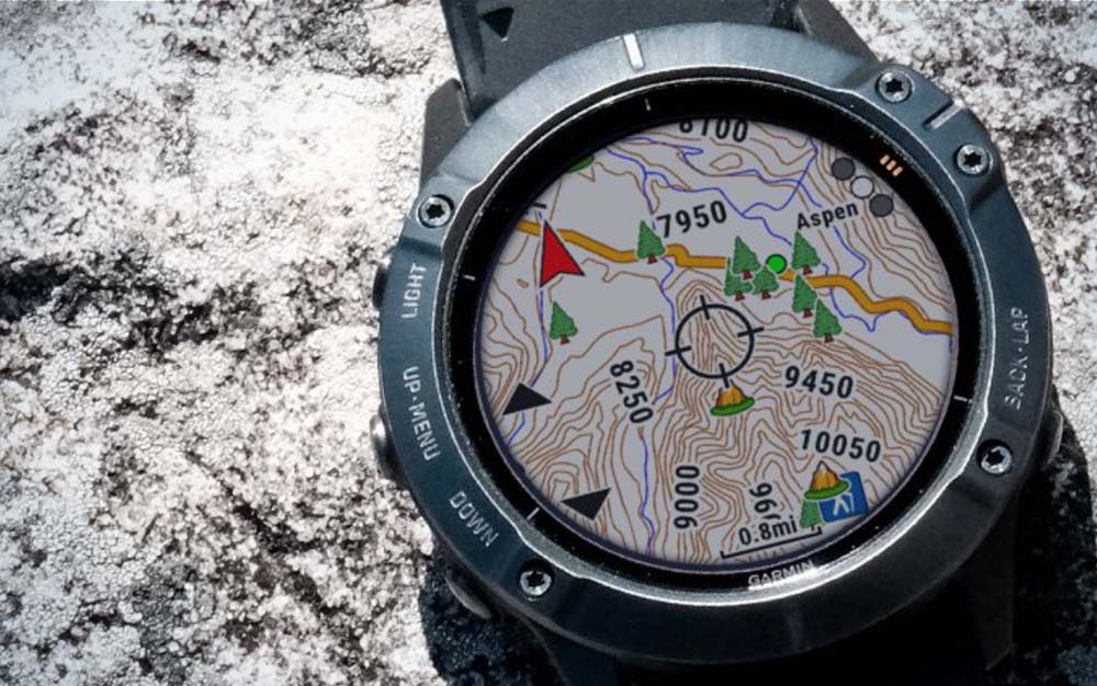 A Garmin Fenix 6 with a GPS map projected on its screen