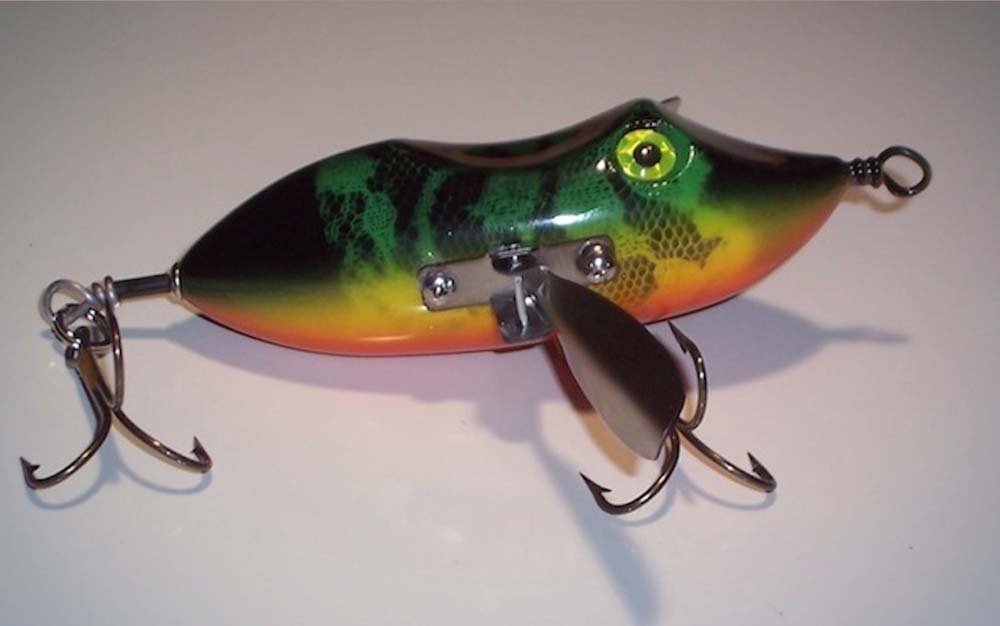 A green fish-shaped musky lure with orange on its belly