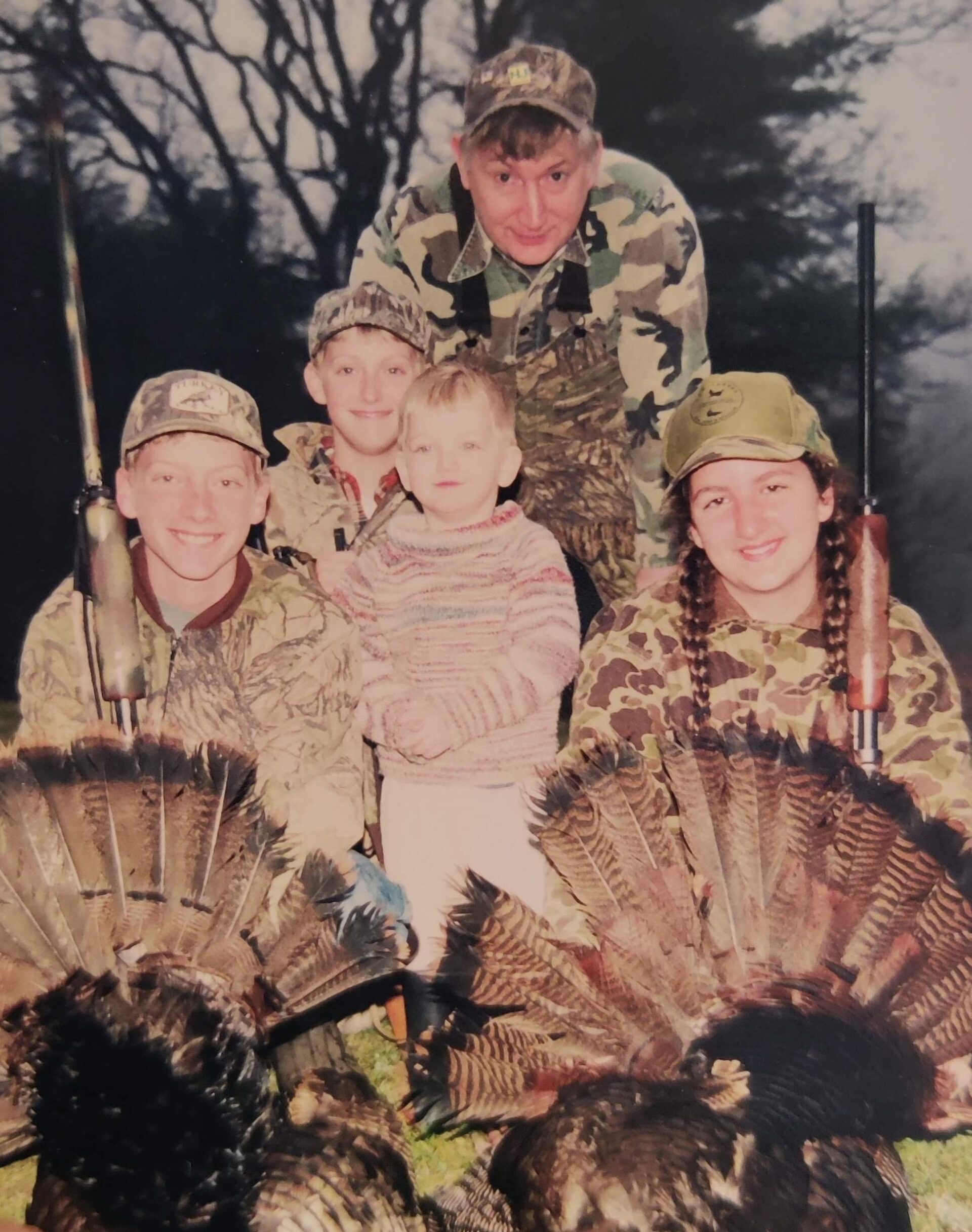 A vintage photo of a family turkey hunt.