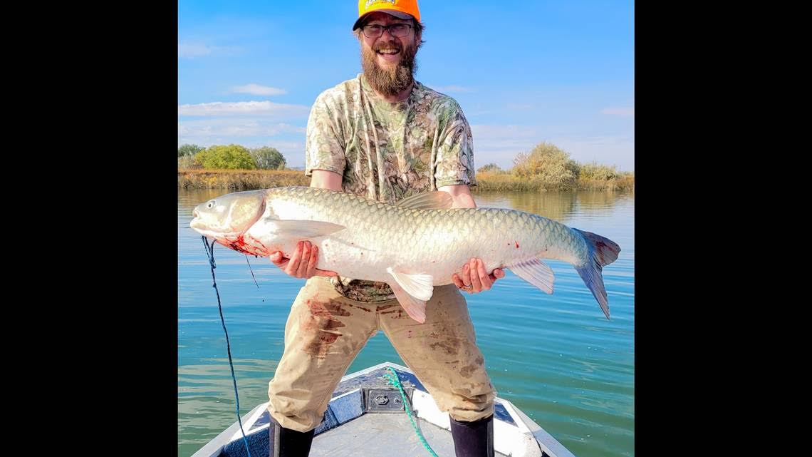 Cris Endicott of Meridian, Idaho caught his record grass carp on rod and reel. 