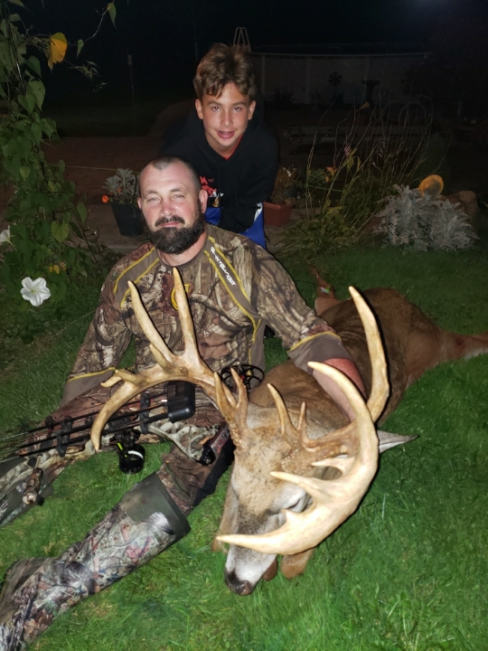 This big New York buck was taken by Scott McQueen, pictured here with his son.