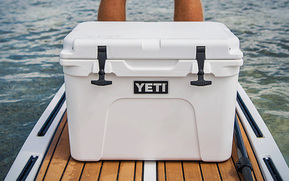 A white YETI cooler on the dock of a boat
