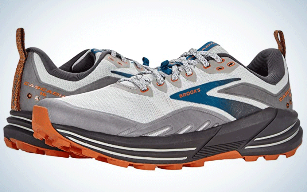 A pair of grey running shoes with blue and orange accents