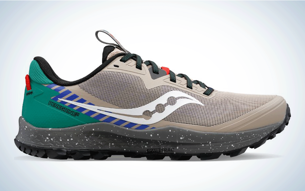 A grey running shoe with green and blue accents