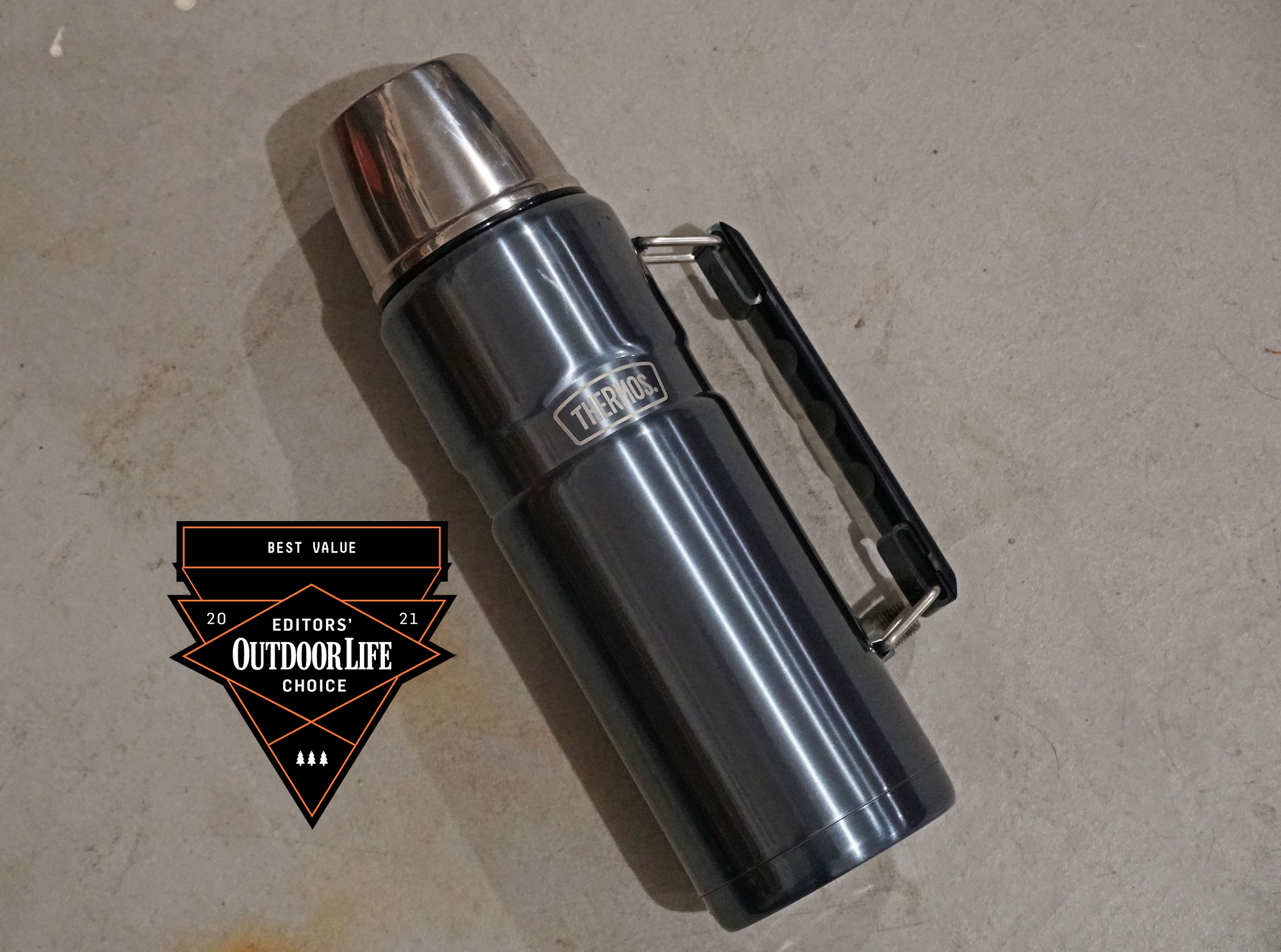 A blue Thermos with a handle and silver cap