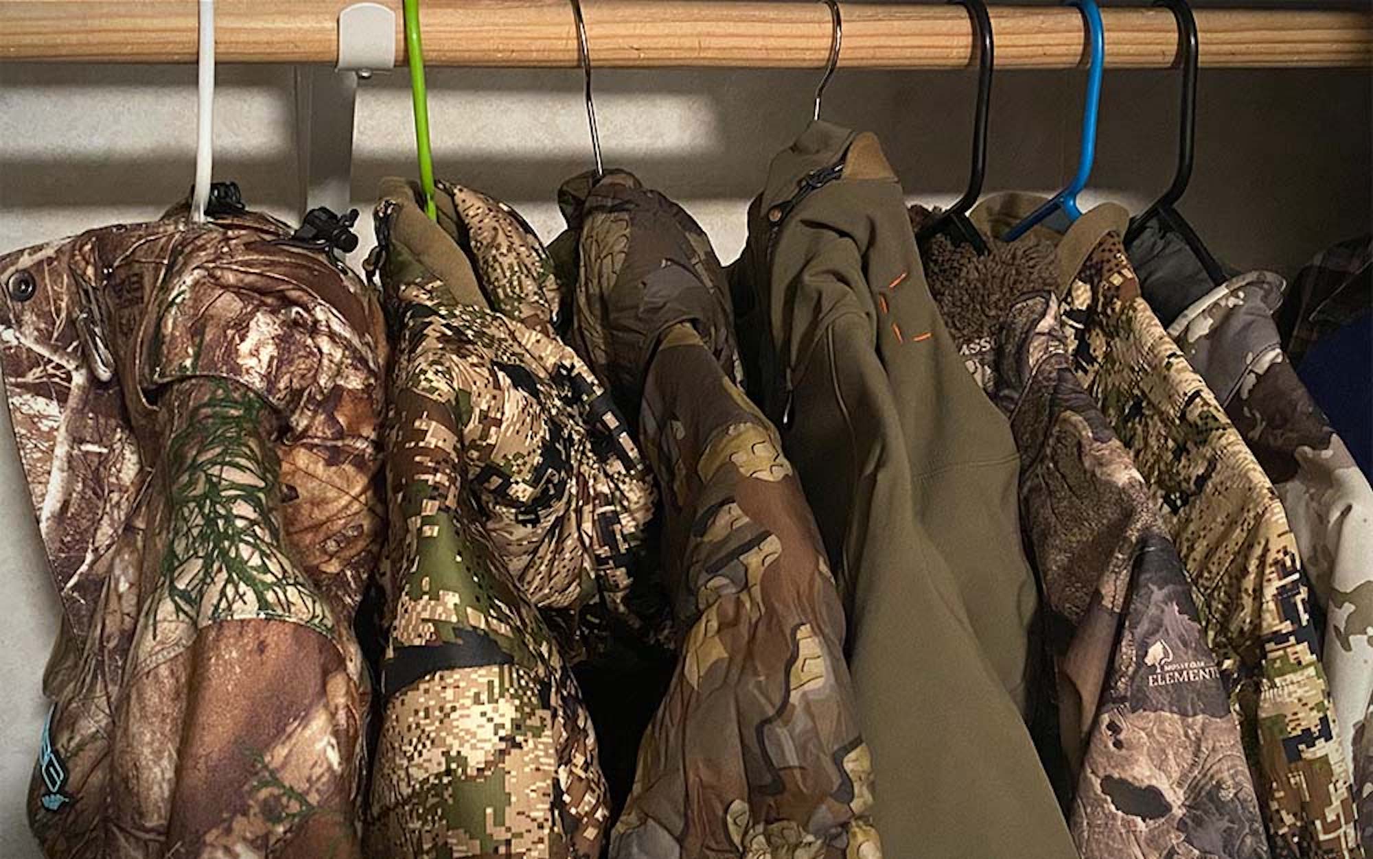 Seven of the best women's hunting jackets hanging in a closet