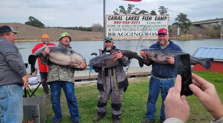 The winning team, Catastrophic Failure, with their blue catfish.
