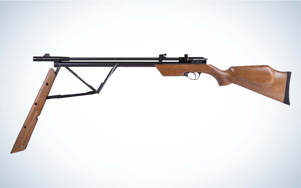 A brown wooden air rifle with a black barrel