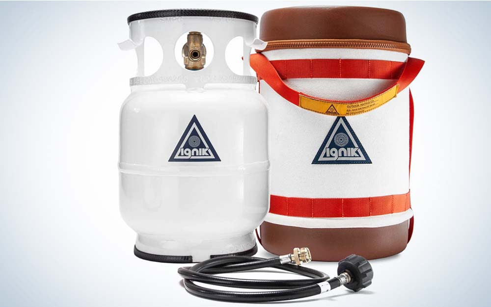 A white gas tank next to a carrying case and a hose