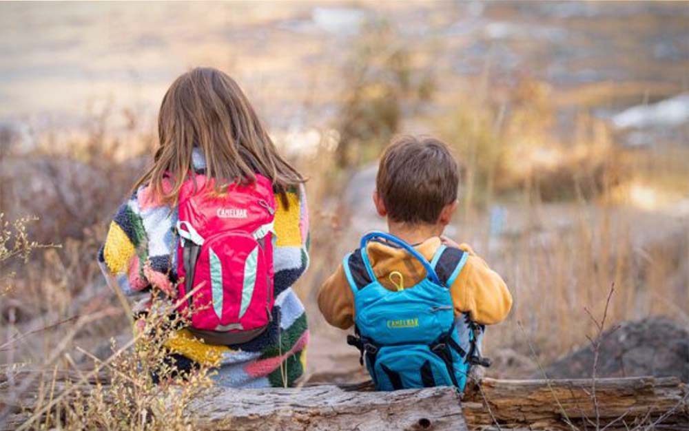 Two children wearing hiking backpacks