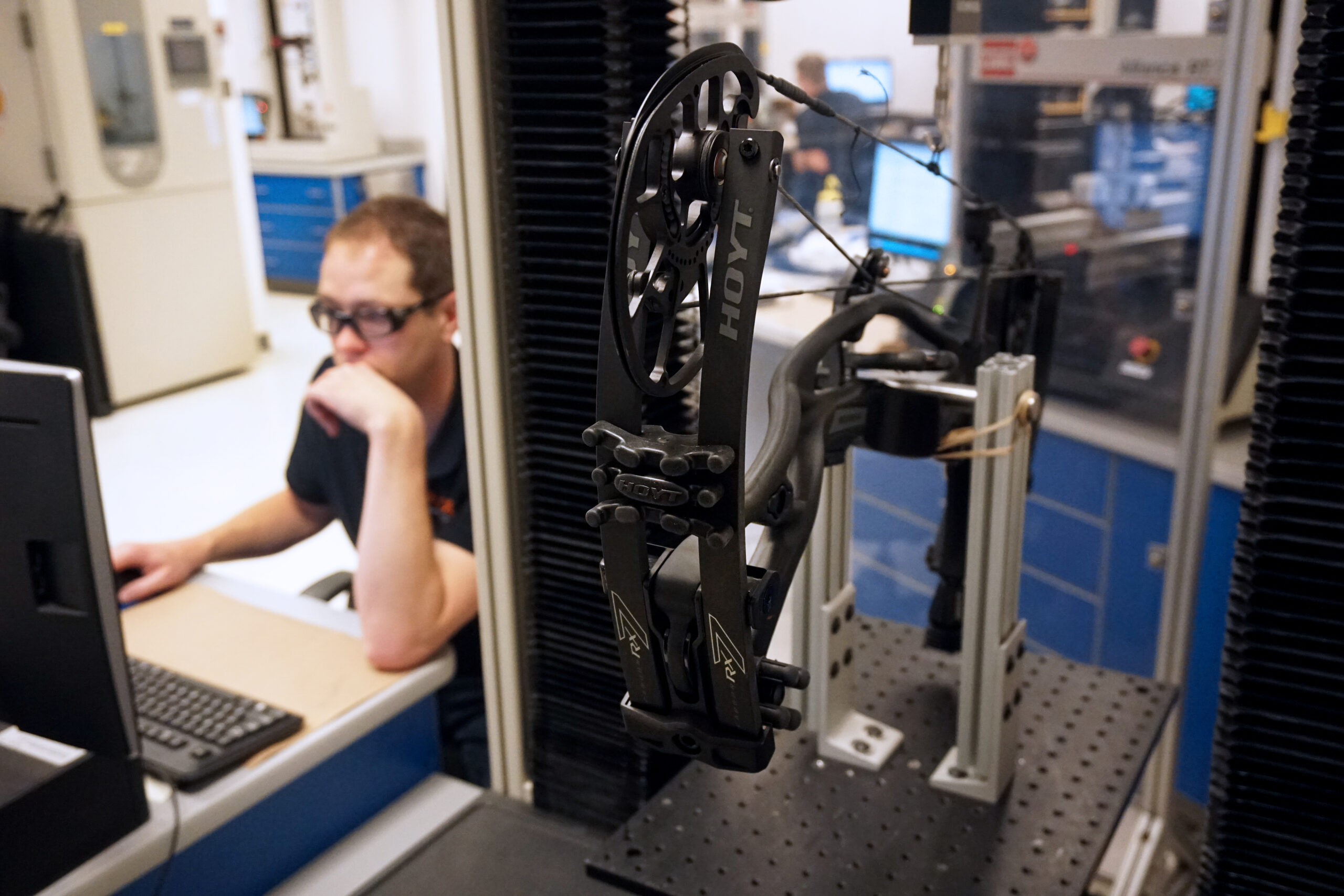 An engineer at Stress Engineering Services records a draw force curve in the lab.