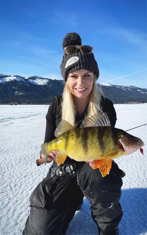 A woman holding a large yellow fish