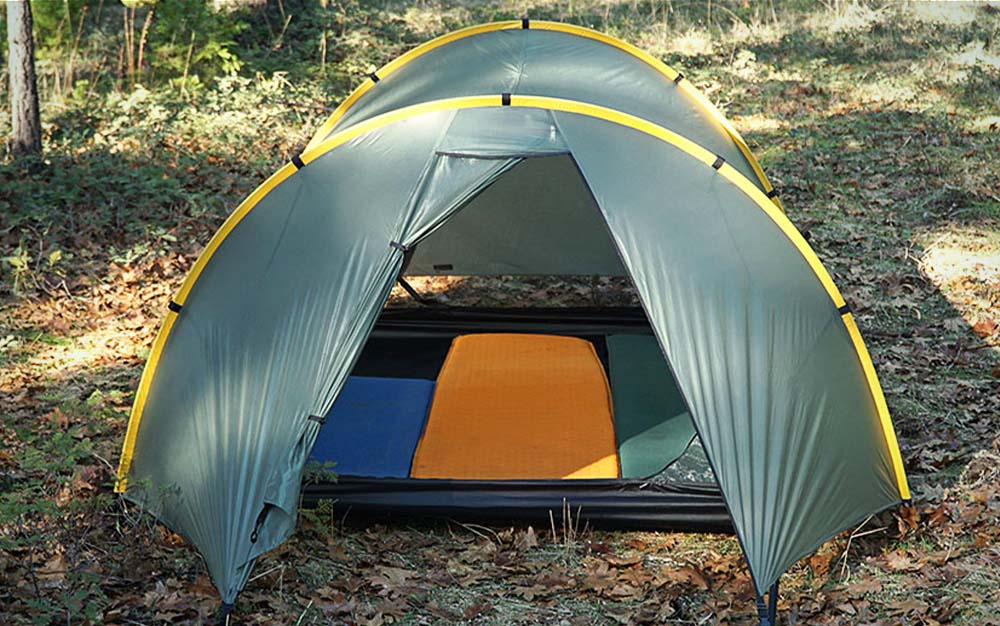 A green dome best backpacking tent set up in the woods