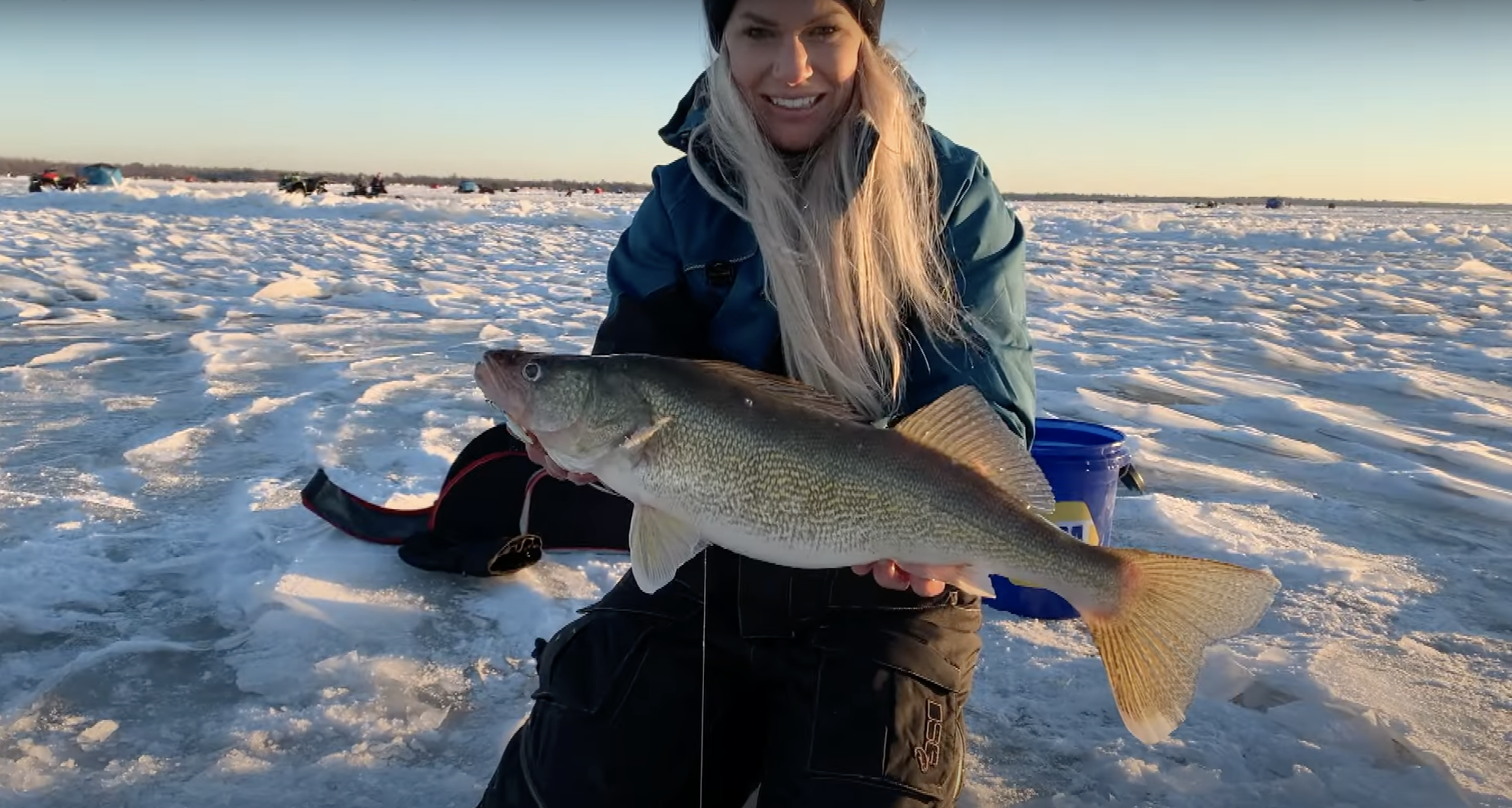 angler using the best ice fishing lines to catch a walleye