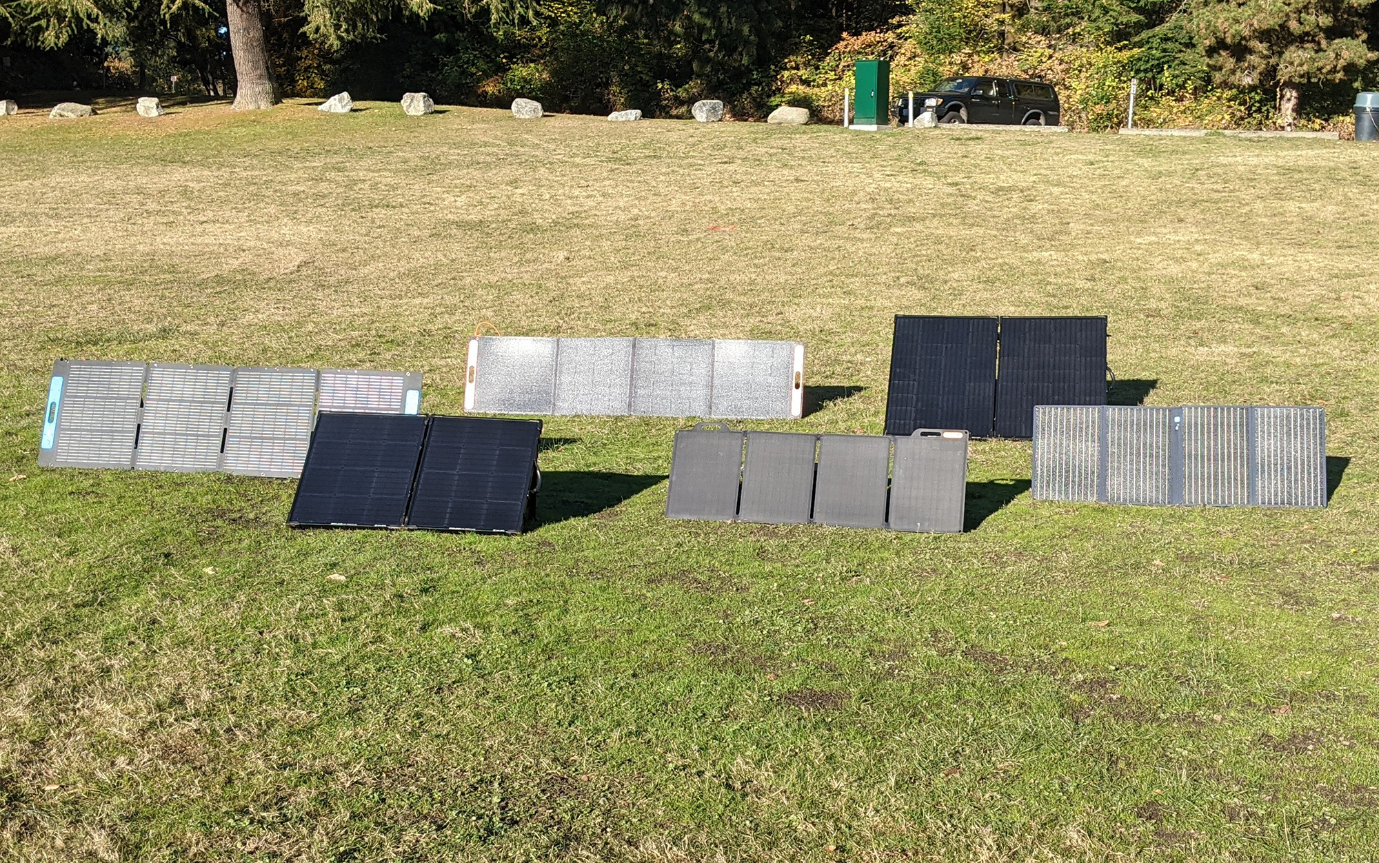 Solar panels sitting in the grass.