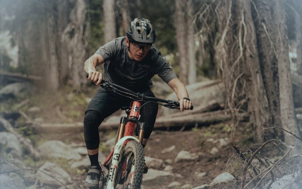 A man riding a best mountain bike through the woods