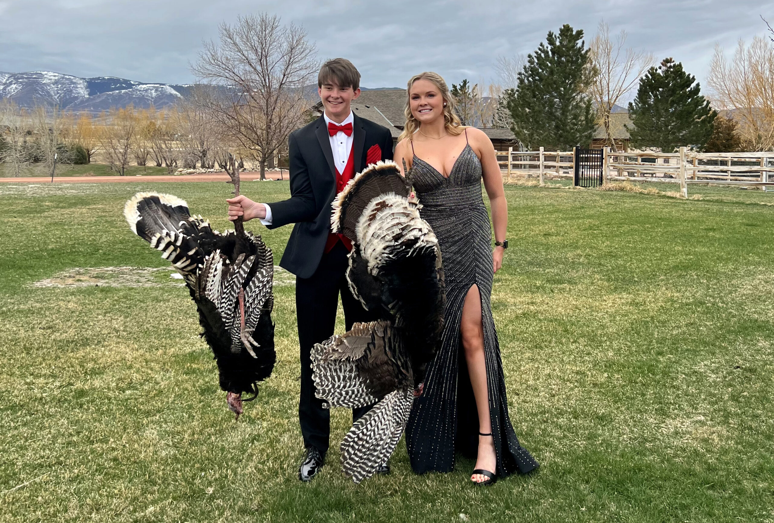 Two Wyoming teens with their turkeys before they head to prom.