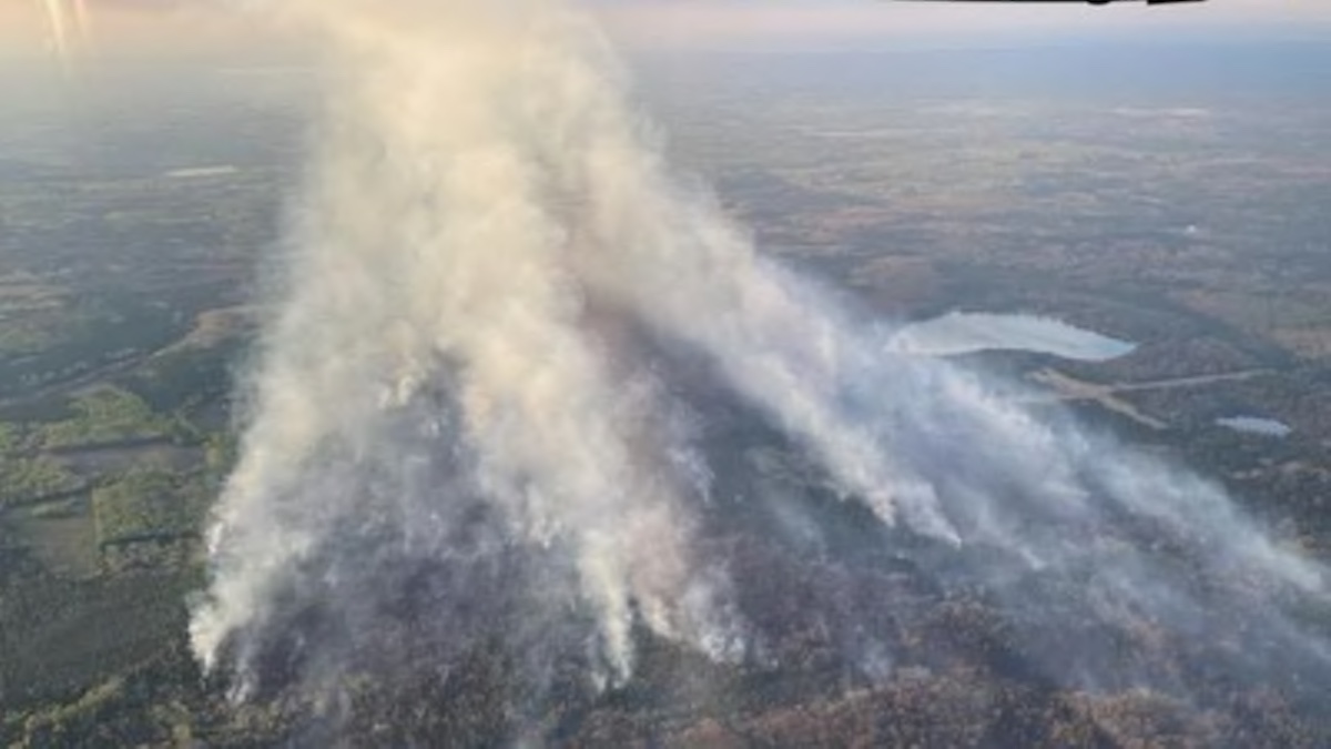 A wildfire in Michigan caused the evacuation of 13 individuals at a hunting camp.