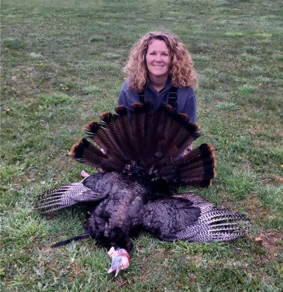 A female hunter with her first longbeard turkey.