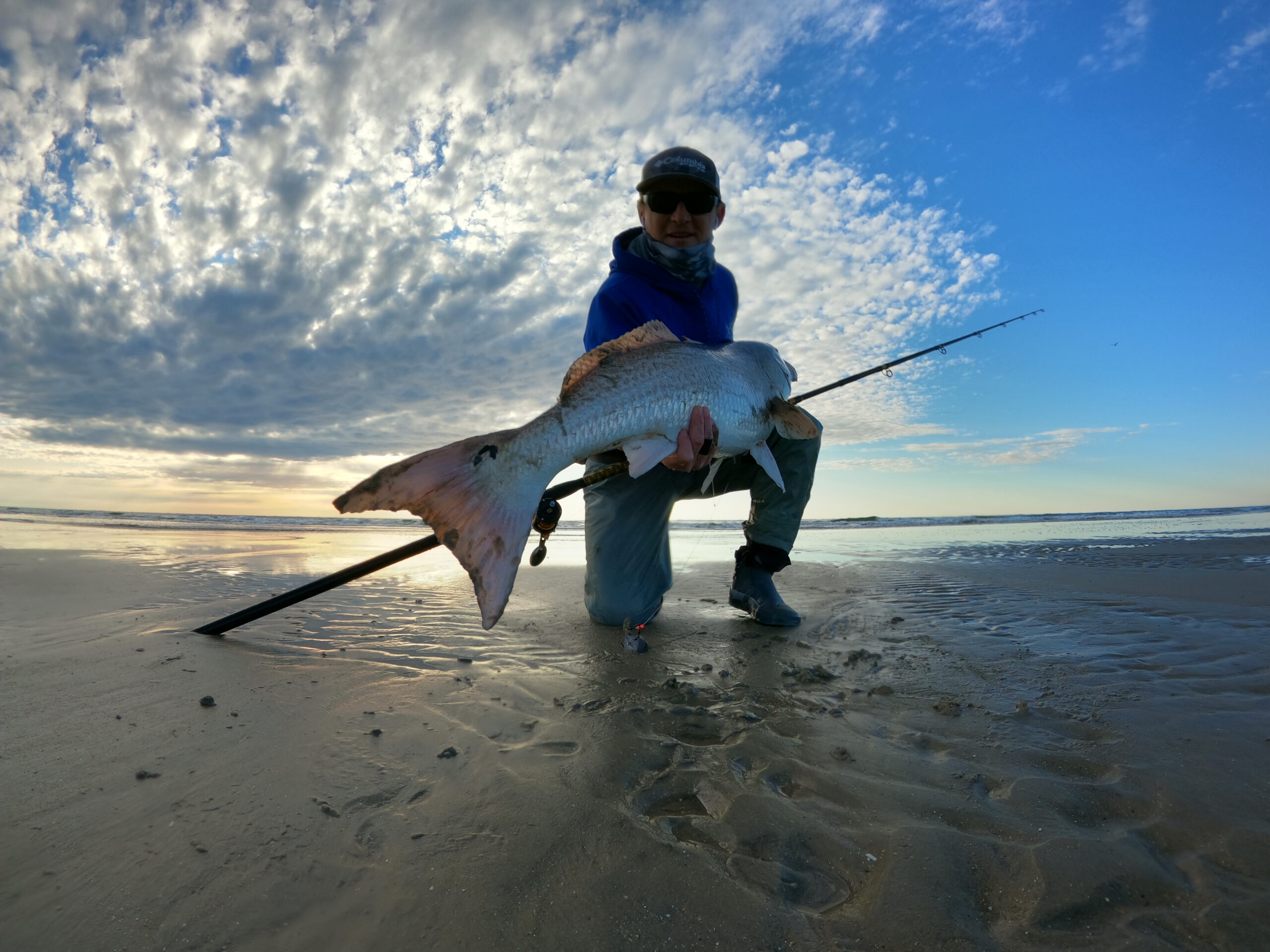 The author with a red drum caught testing the best surf fishing reels