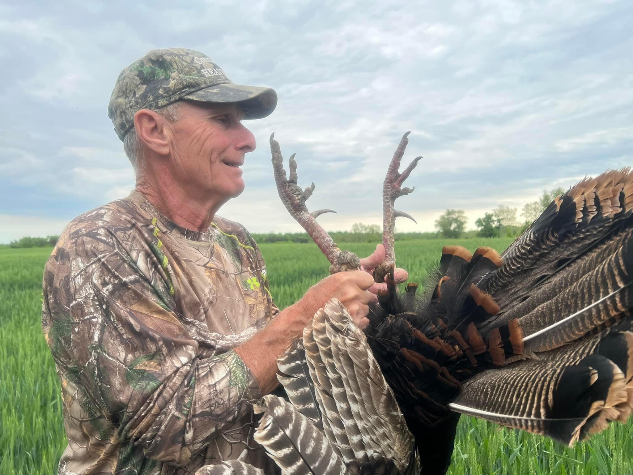 Harry Daley checks out the gobbler's impressive spurs.