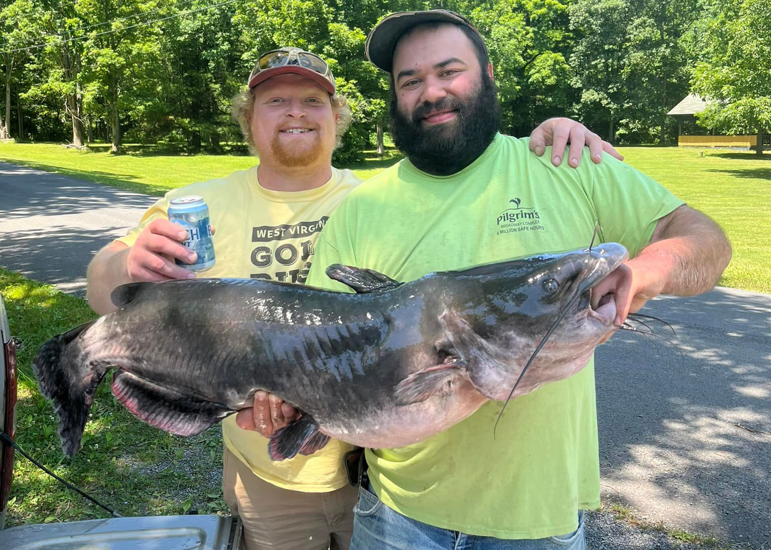 Burkett (left) and his buddy holding the state record channel cat.
