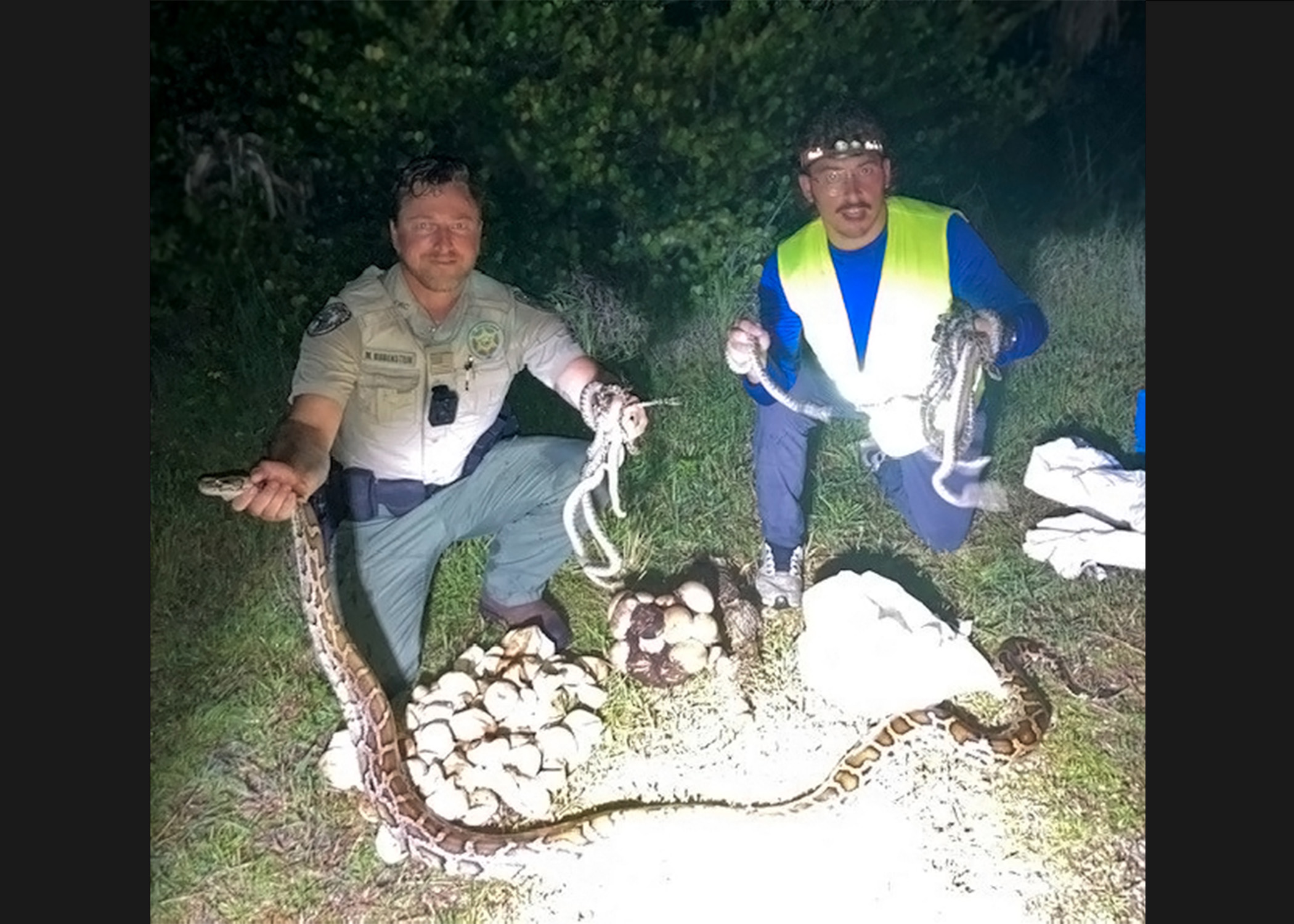 FWC officer Matthew Rubenstein (left) and trapper Alex McDuffie show off their haul. 
