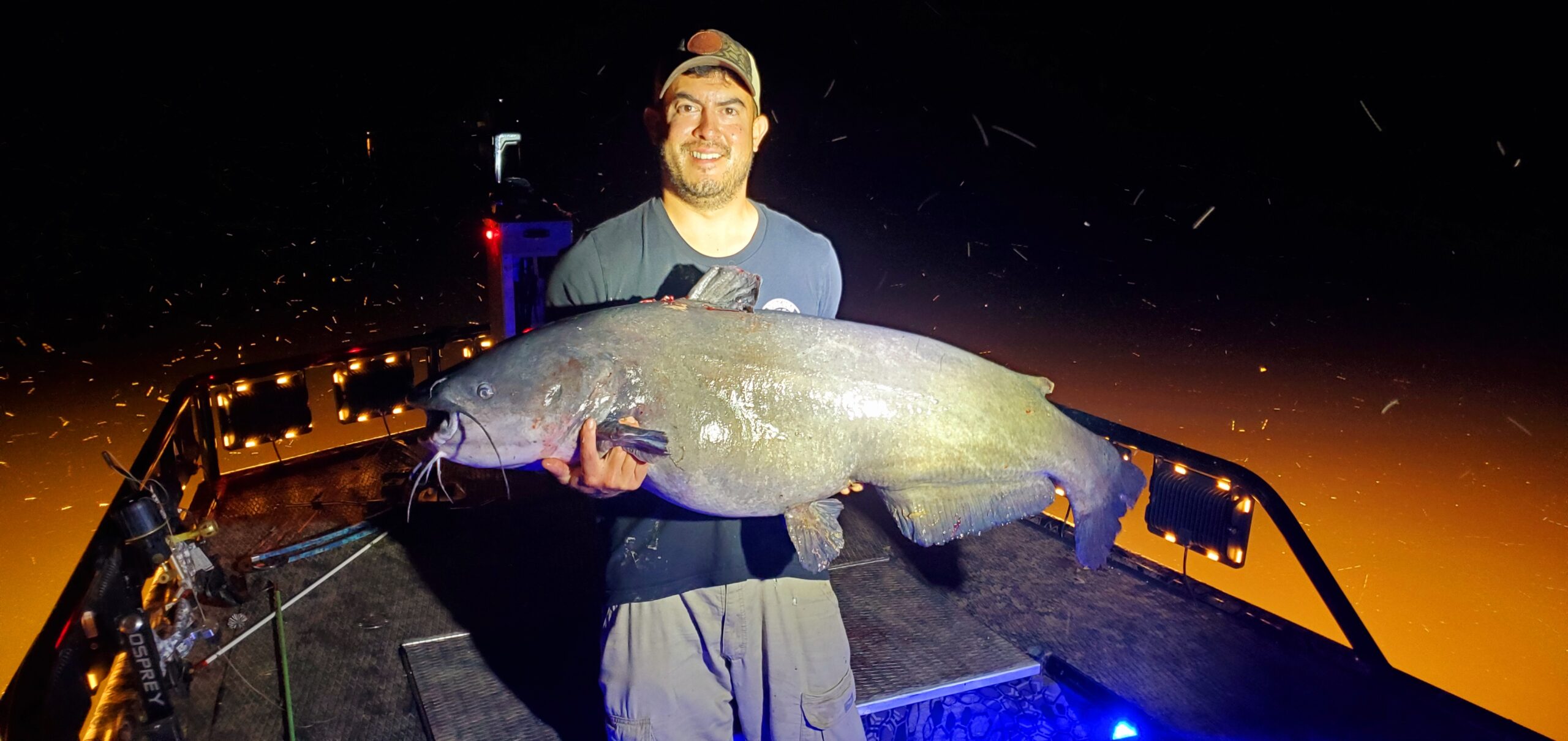 Jason Emmel holding the record breaking blue catfish he shot.