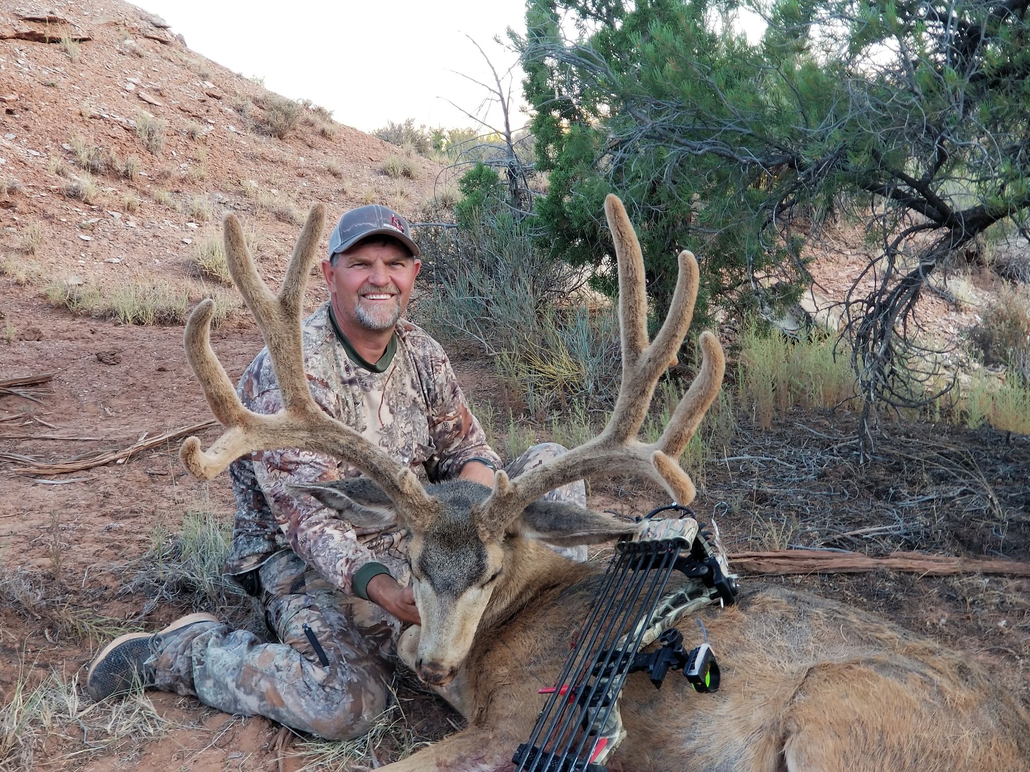 A western mule deer hunter with a giant mule deer buck.