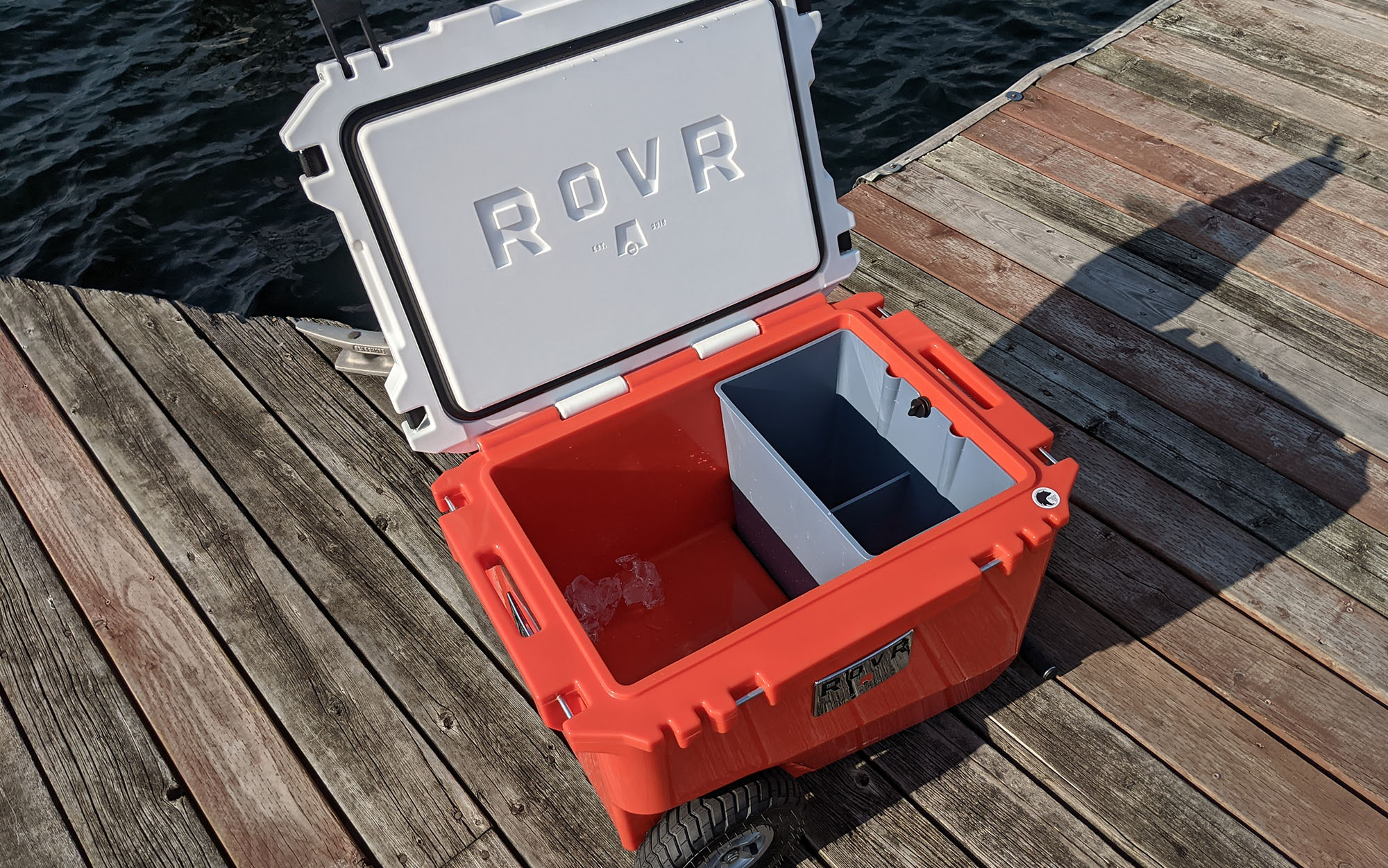 ROVR RollR cooler sits open on a dock.