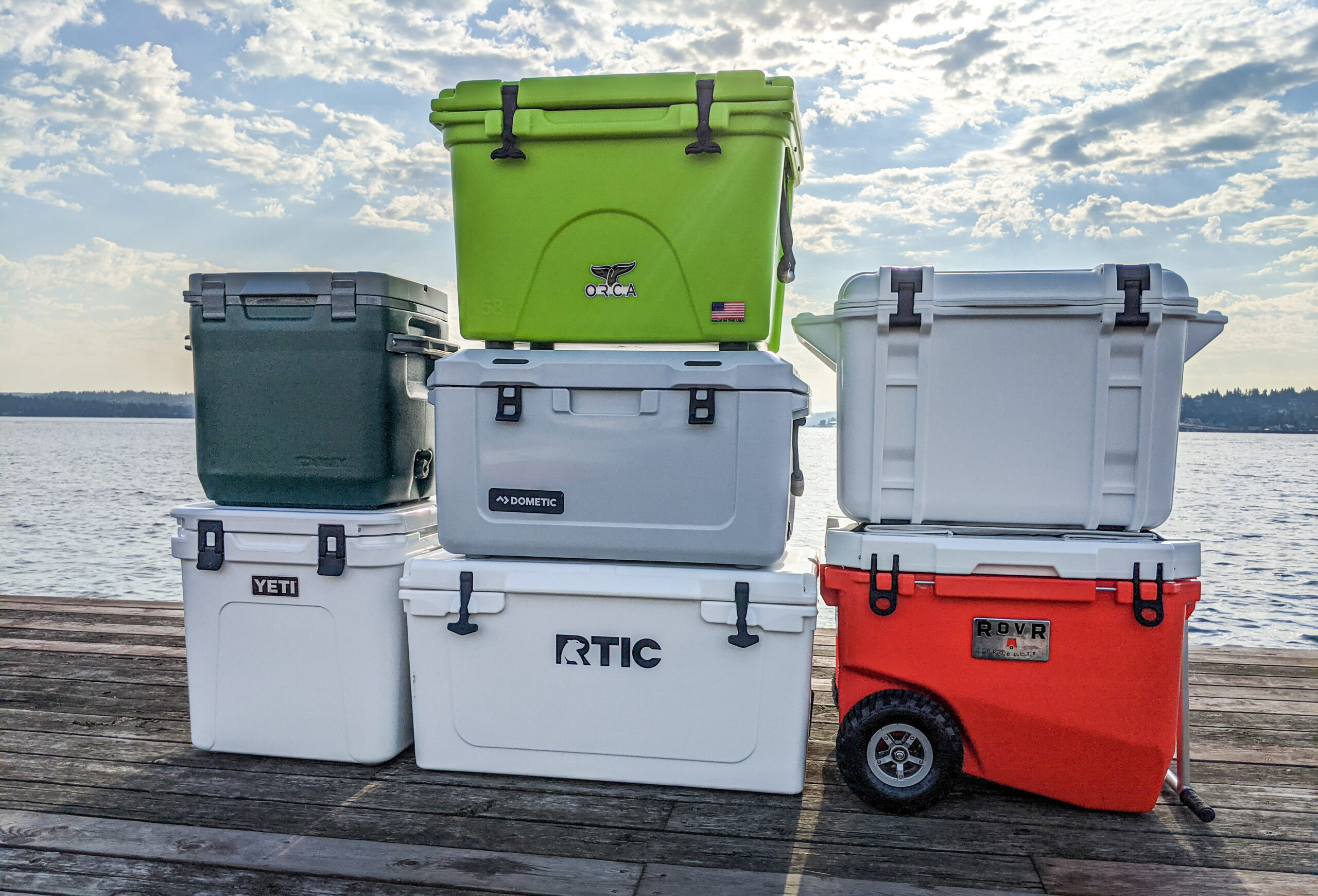A stack of the best camp coolers on a dock.