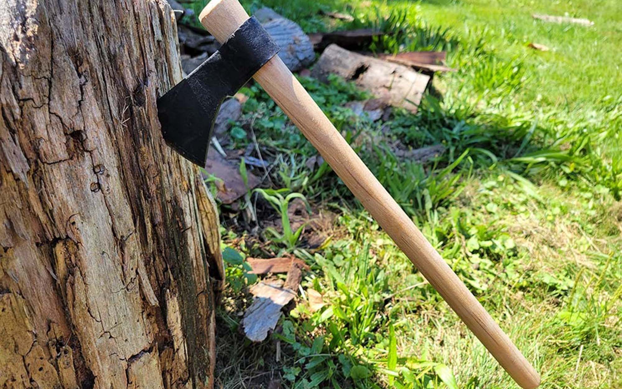 Mouse Hawk tomahawk stuck into a tree stump.