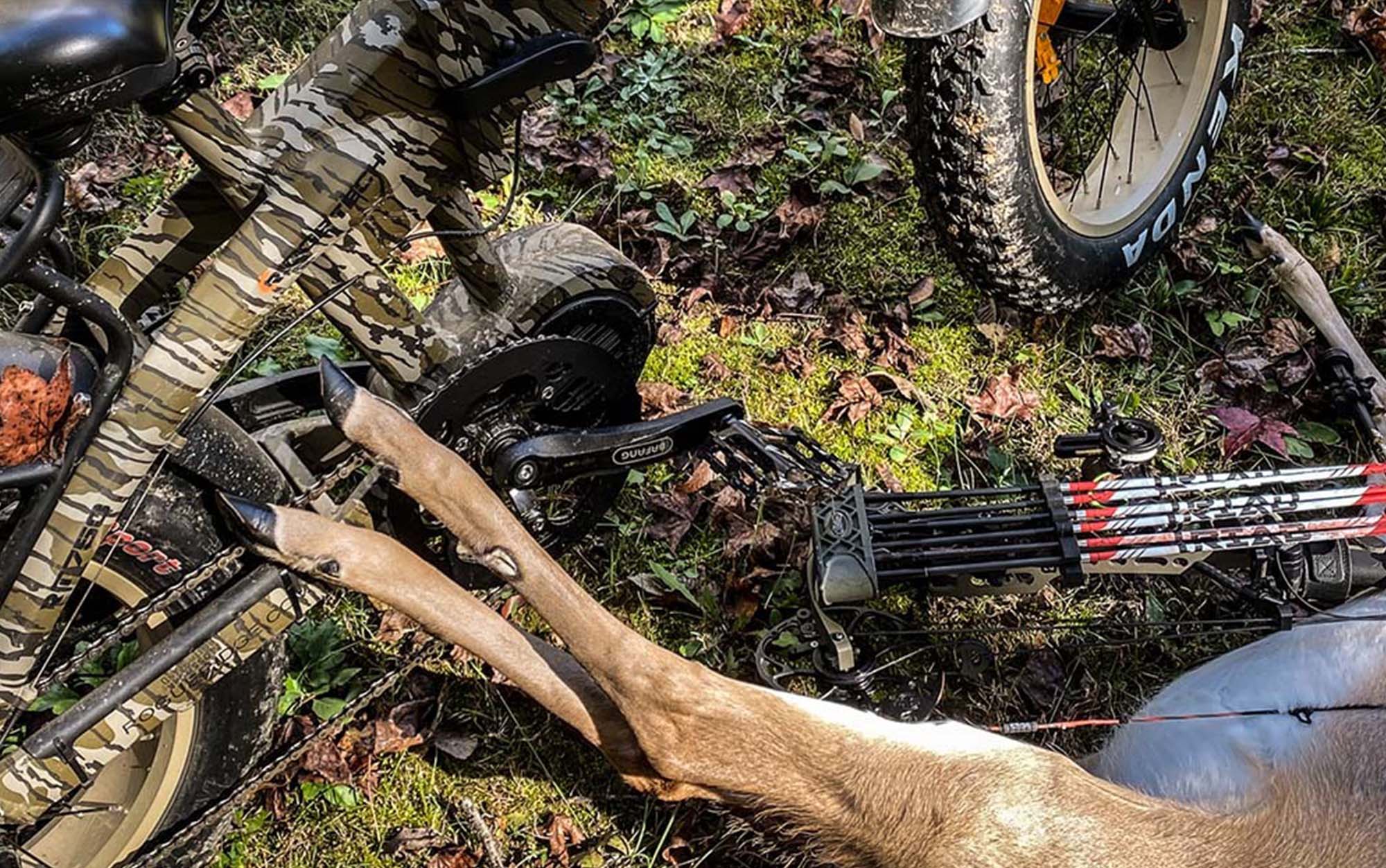 A hunting ebike next to a downed deer.