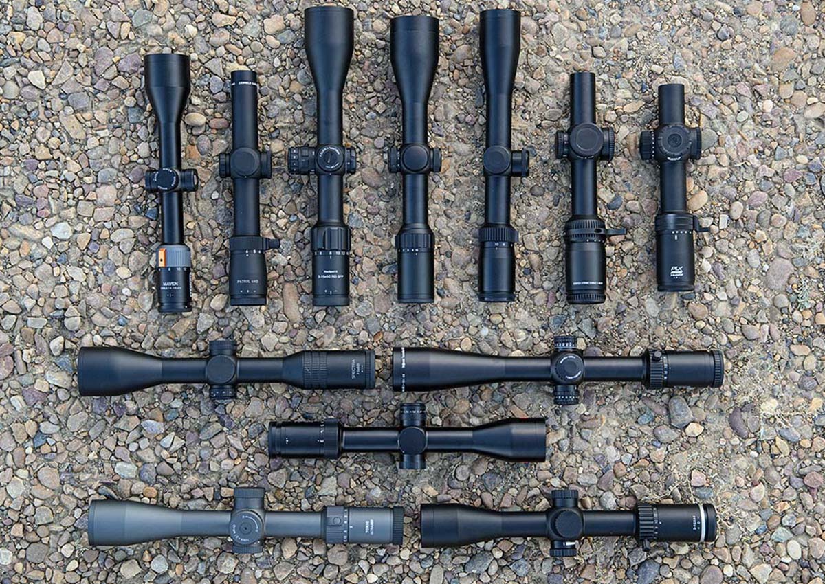 The best rifle scopes for deer hunting laid out on rocks.