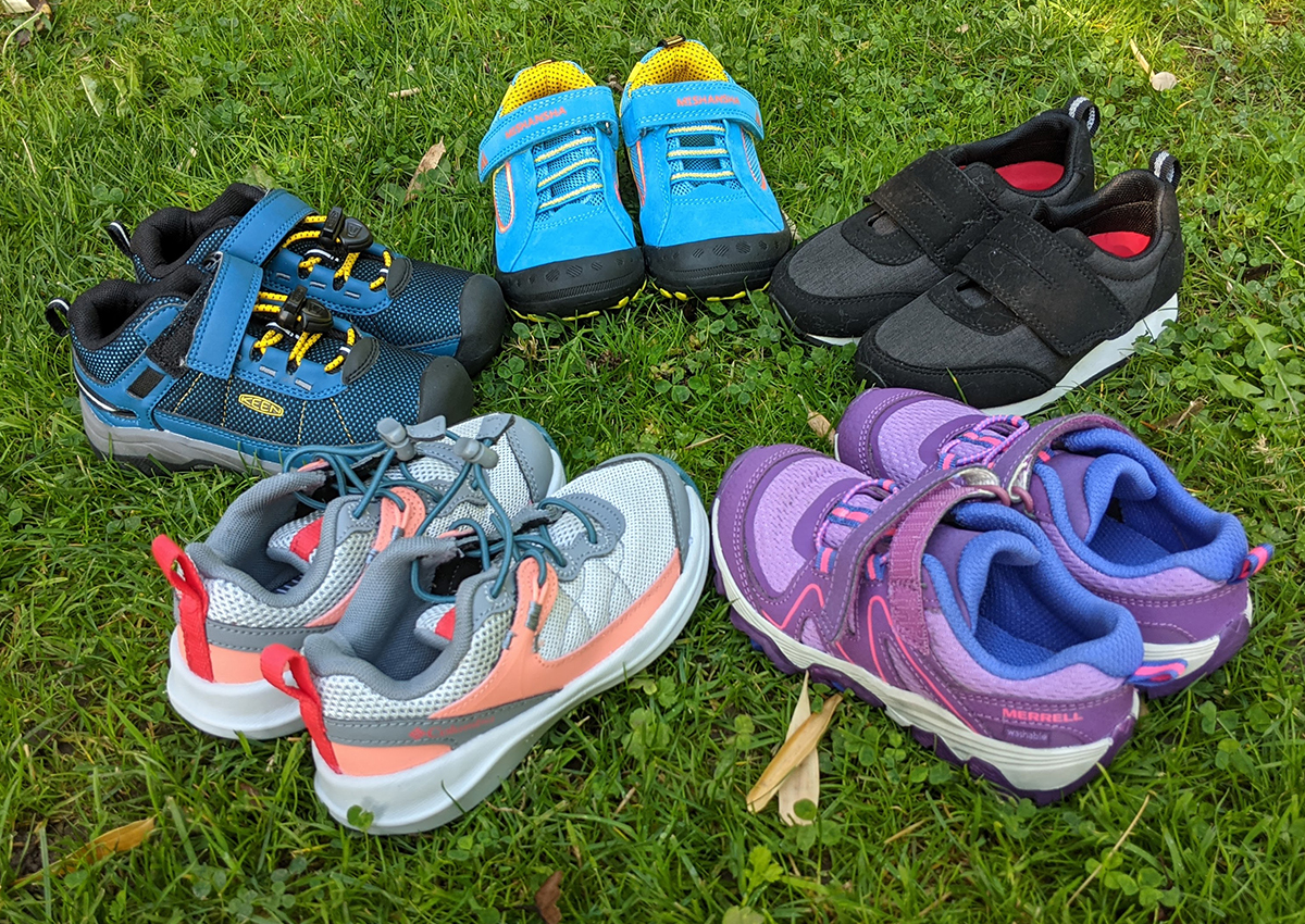 The best hiking shoes for kids sitting in a circle.