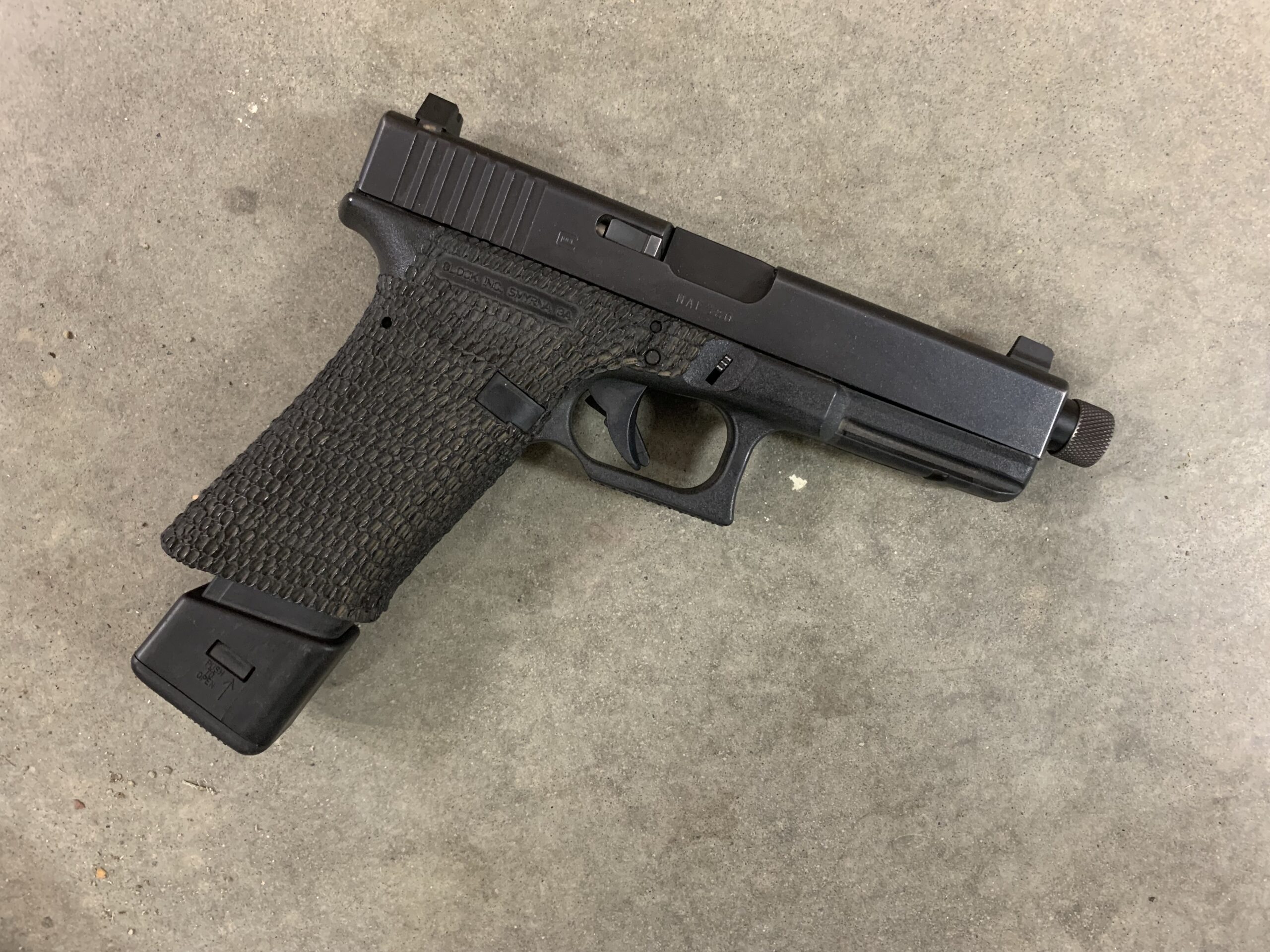 Glock G17 with modified frame, aftermarket barrel, sights, and magazine extention