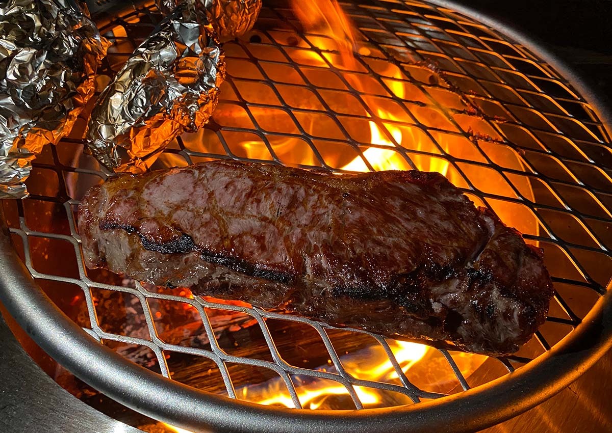 Author cooks a steak on the Breeo Grill.