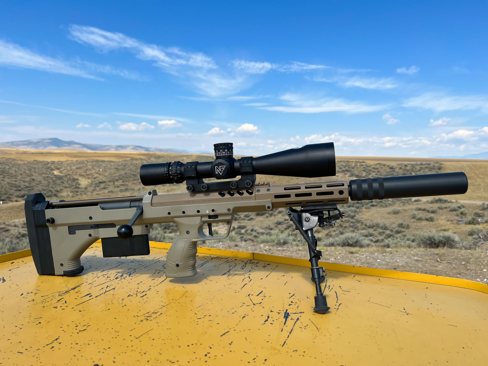 Desert Tech SRS rifle with silencer propped on a shooting bench