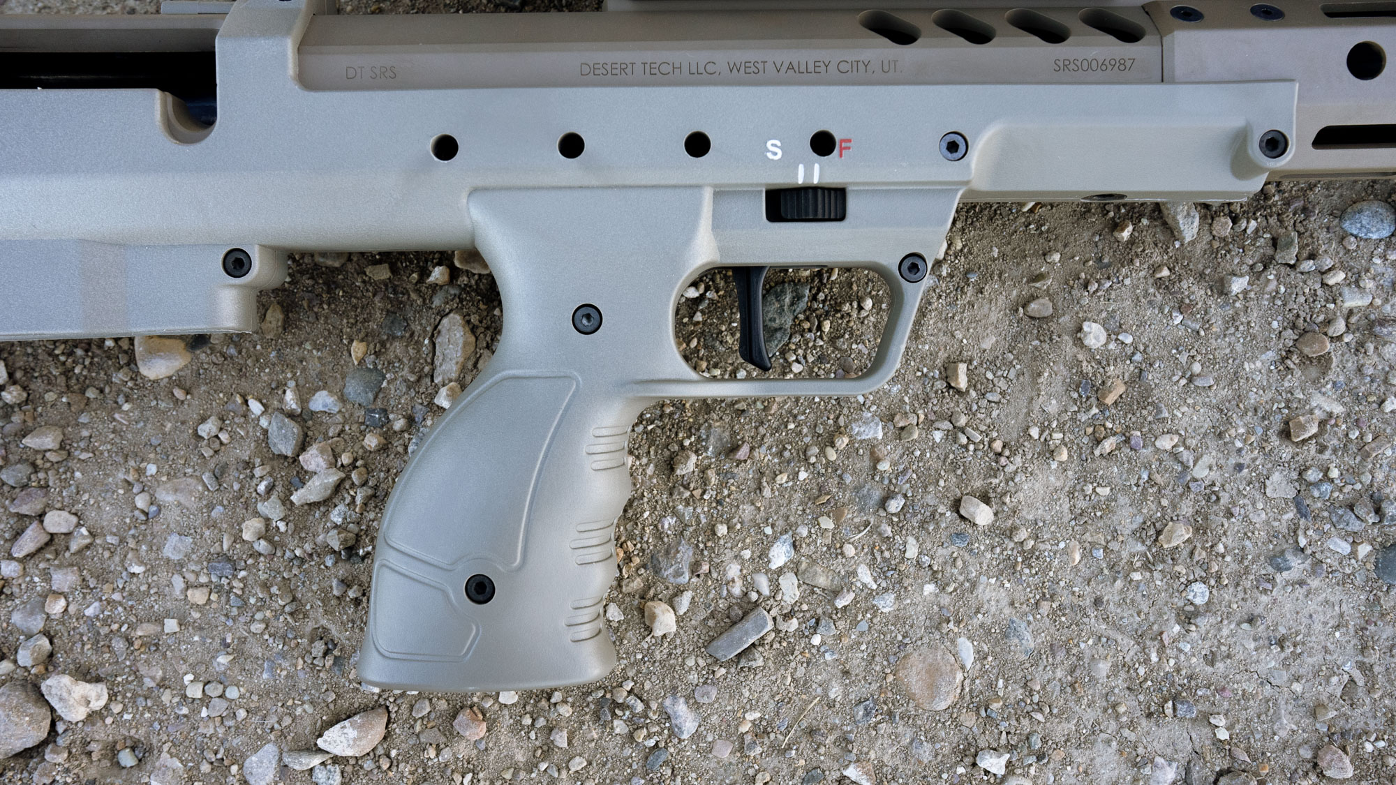 closeup shot of the grip on the desert tech srs a2 showing the trigger and two-position safety