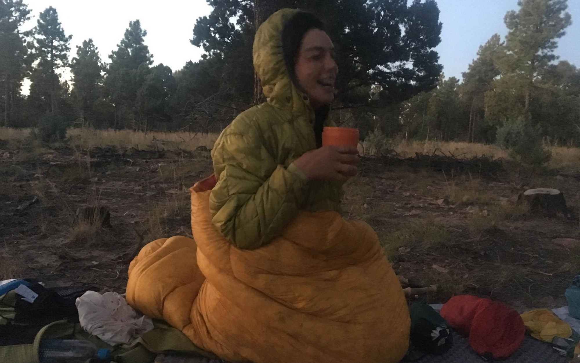 A woman in a sleeping bag on the trail.