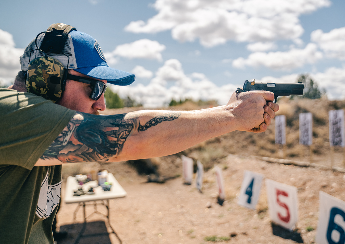 A man shoots a 9mm at the range.
